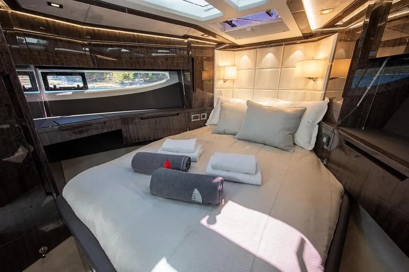  Yacht Photos Pics Luxurious bedroom interior of 2023 Galeon 500 Fly yacht with elegant bedding and ambient lighting.