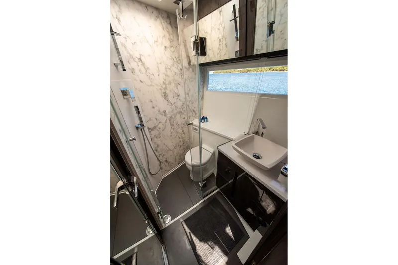  Yacht Photos Pics Luxurious bathroom in 2023 Galeon 500 Fly yacht with marble walls and modern fixtures.