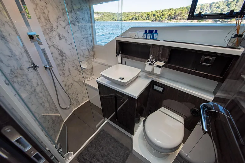  Yacht Photos Pics Luxurious bathroom in 2023 Galeon 500 Fly yacht with marble shower and modern fixtures.