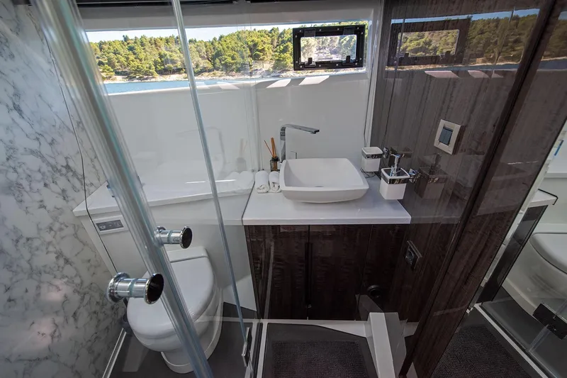  Yacht Photos Pics Luxurious bathroom in 2023 Galeon 500 Fly yacht with modern fixtures and scenic window view.