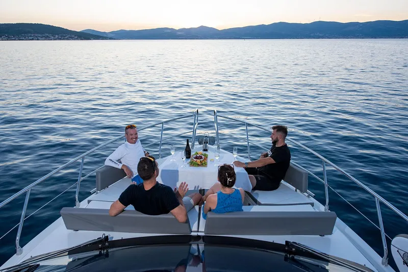  Yacht Photos Pics People dining on the deck of a 2023 Galeon 500 Fly yacht at sunset.