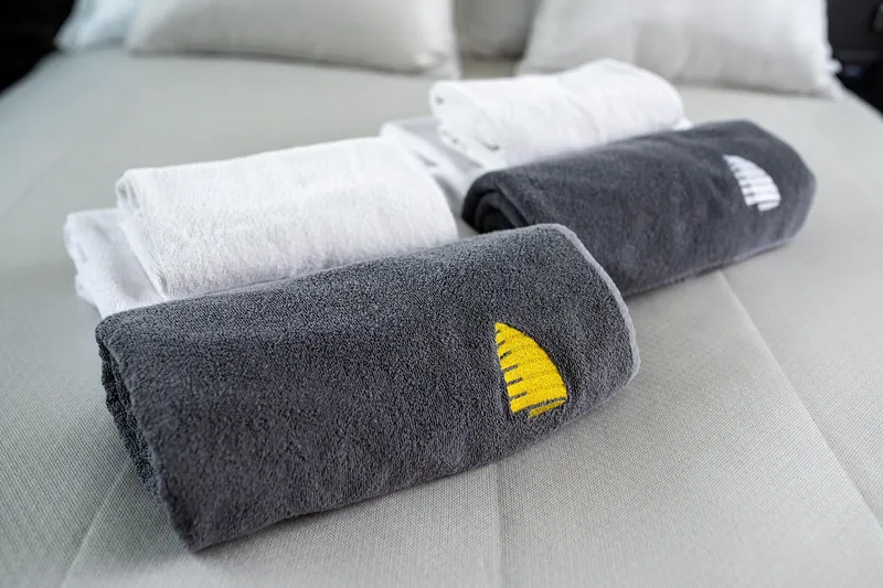  Yacht Photos Pics Luxury towels on Galeon 500 Fly yacht, 2023 model, featuring elegant embroidered designs.