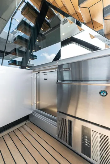 Chop Chop Yacht Photos Pics 2023 Riva Dolcevita yacht interior with modern stainless steel appliances and wooden flooring.