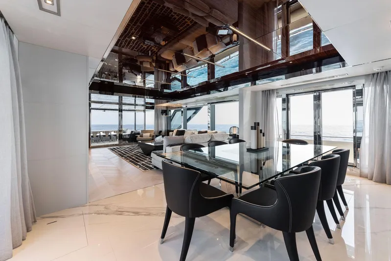 Chop Chop Yacht Photos Pics Luxurious interior of 2023 Riva Dolcevita yacht with elegant dining area and panoramic views.