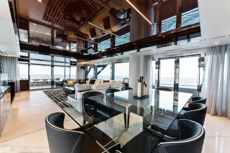 Chop Chop Yacht Photos Pics Luxurious interior of 2023 Riva Dolcevita yacht with modern dining area and ocean view.