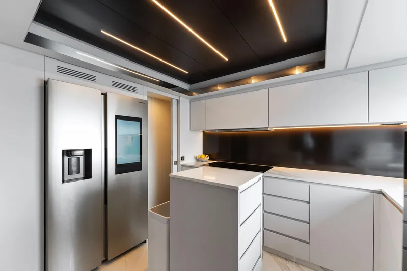 Chop Chop Yacht Photos Pics Modern kitchen interior on 2023 Riva Dolcevita yacht with sleek design and stainless steel appliances.