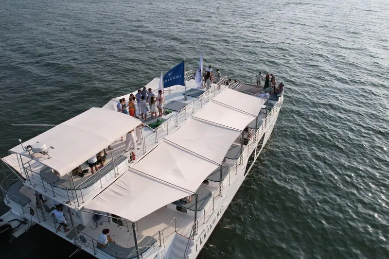  Yacht Photos Pics Aerial view of a 2027 Custom PAXCAT yacht with people enjoying a sunny day.