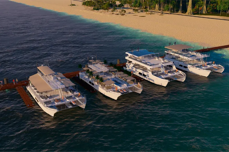  Yacht Photos Pics Four Custom PAXCAT 2027 yachts docked at a tropical beach pier.