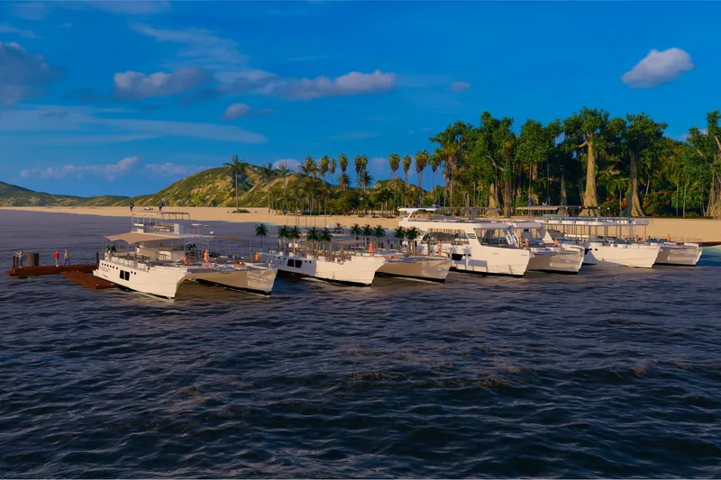  Yacht Photos Pics Custom PAXCAT 2027 catamarans docked at tropical island with lush greenery.