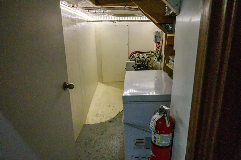 Starlight Yacht Photos Pics Basement storage area with fire extinguisher and electrical equipment on Custom Expedition Vessel 58.