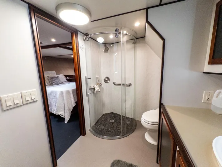 Starlight Yacht Photos Pics Luxurious bathroom in 1986 Custom Expedition Vessel 58 with modern shower and adjacent bedroom.