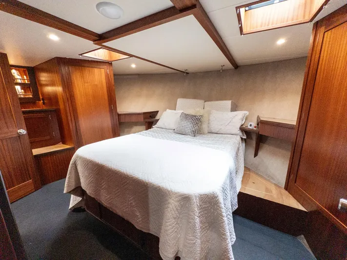 Starlight Yacht Photos Pics Luxurious cabin interior of 1986 Custom Expedition Vessel 58 with cozy bed and wooden accents.
