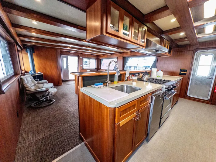 Starlight Yacht Photos Pics Luxurious interior of 1986 Custom Expedition Vessel 58 with modern kitchen and seating area.