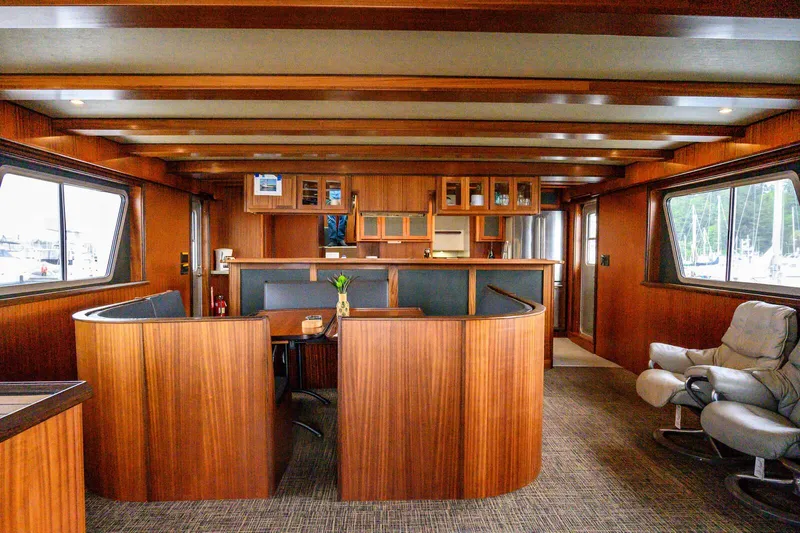 Starlight Yacht Photos Pics Luxurious interior of 1986 Custom Expedition Vessel 58 with wood paneling and comfortable seating.