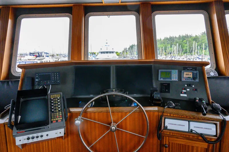 Starlight Yacht Photos Pics Cockpit of 1986 Custom Expedition Vessel 58 with navigation equipment and steering wheel.