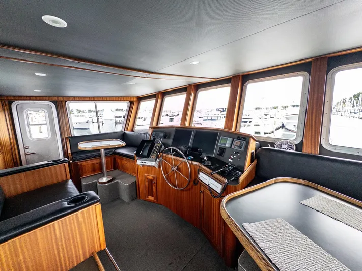 Starlight Yacht Photos Pics Interior of 1986 Custom Expedition Vessel 58 with wooden paneling and navigation equipment.