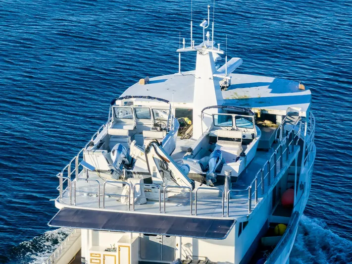 Starlight Yacht Photos Pics Custom Expedition Vessel 58, 1986, cruising on blue ocean waters.