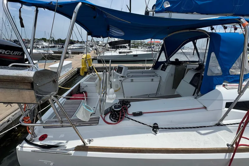 Layover Yacht Photos Pics 2018 Jeanneau Sun Odyssey 389 sailboat docked, featuring blue canopy and modern cockpit design.