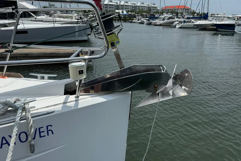 Layover Yacht Photos Pics Jeanneau Sun Odyssey 389 (2018) anchored at marina, showcasing bow and anchor detail.