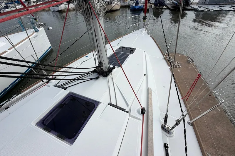 Layover Yacht Photos Pics 2018 Jeanneau Sun Odyssey 389 sailboat deck with rigging in marina.