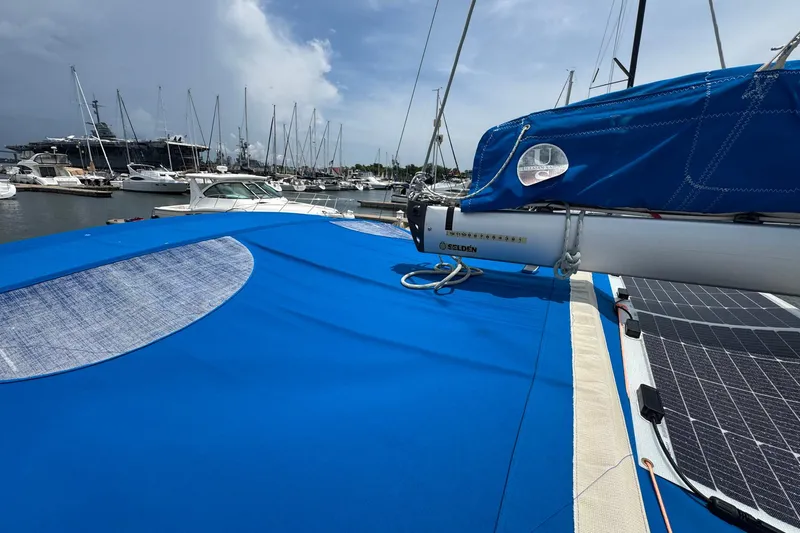 Layover Yacht Photos Pics 2018 Jeanneau Sun Odyssey 389 sailboat with blue cover docked at marina.