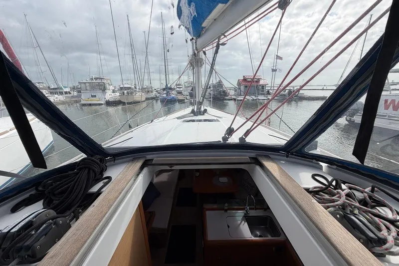 Layover Yacht Photos Pics 2018 Jeanneau Sun Odyssey 389 sailboat docked in a marina, interior and deck view.