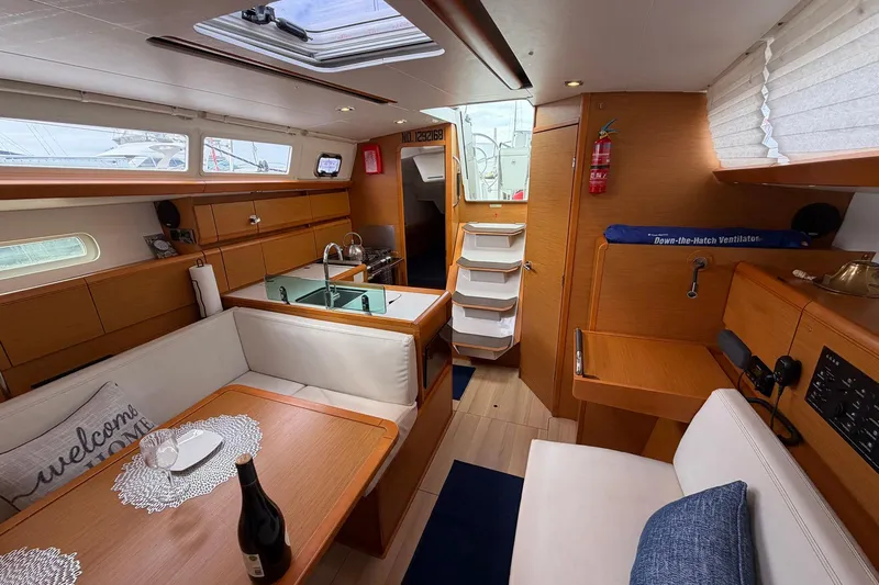 Layover Yacht Photos Pics Interior of 2018 Jeanneau Sun Odyssey 389 yacht with modern furnishings and cozy seating.