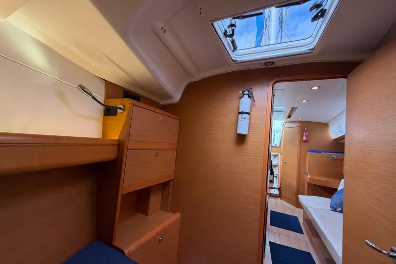 Layover Yacht Photos Pics Interior of 2018 Jeanneau Sun Odyssey 389 sailboat, featuring wood cabinetry and seating.