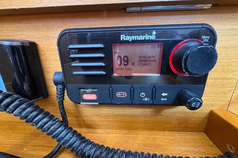 Layover Yacht Photos Pics Raymarine radio on 2018 Jeanneau Sun Odyssey 389, displaying coordinates and boat call.