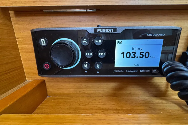 Layover Yacht Photos Pics Fusion MS-AV750 stereo system on Jeanneau Sun Odyssey 389, 2018 model, displaying FM 103.50 MHz.