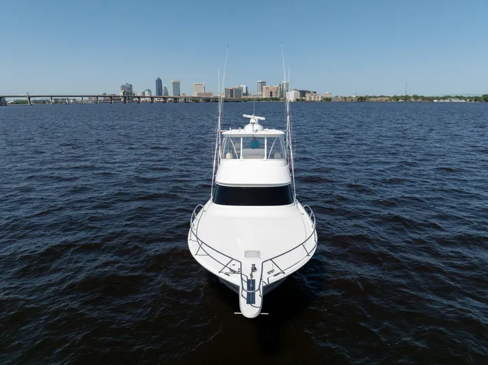 Time Away Yacht Photos Pics 2019 Viking 48 Convertible yacht on open water with city skyline in background.