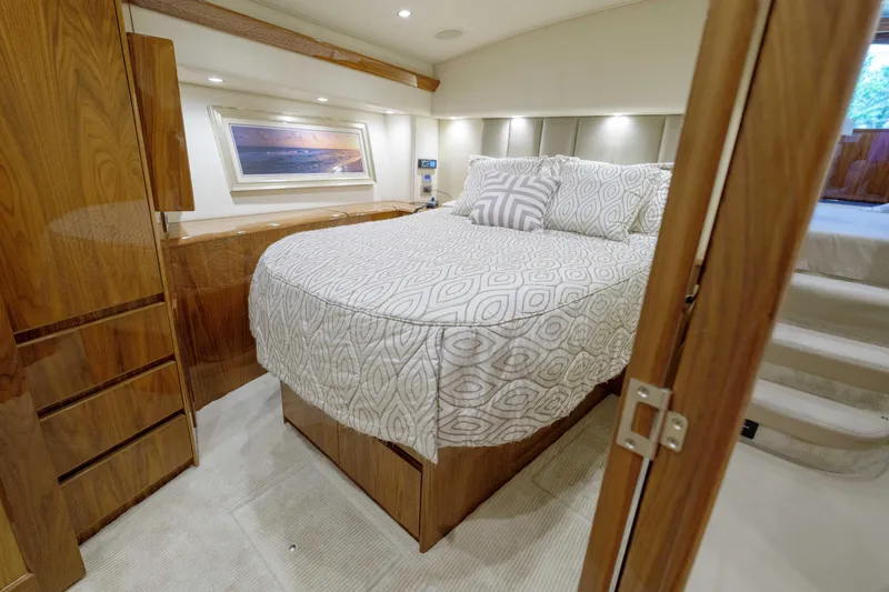 Time Away Yacht Photos Pics Luxurious bedroom interior of 2019 Viking 48 Convertible yacht with elegant wood finishes.