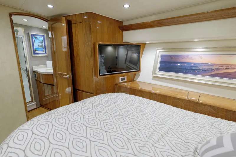 Time Away Yacht Photos Pics Luxurious bedroom interior of 2019 Viking 48 Convertible yacht with TV and ocean view.