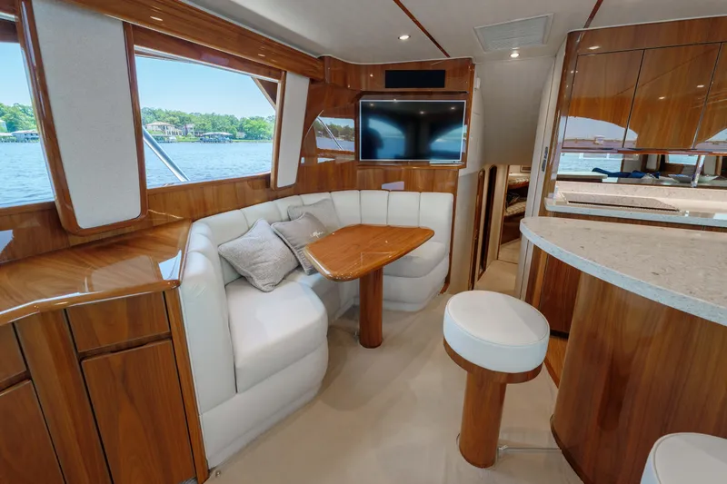 Time Away Yacht Photos Pics Luxurious interior of 2019 Viking 48 Convertible yacht with elegant wood finishes and plush seating.
