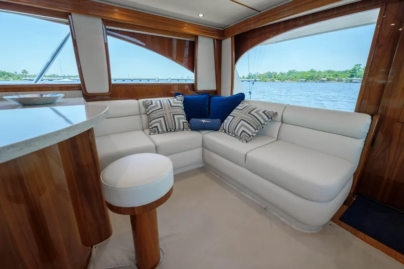Time Away Yacht Photos Pics Luxurious interior of 2019 Viking 48 Convertible yacht with plush seating and scenic window views.