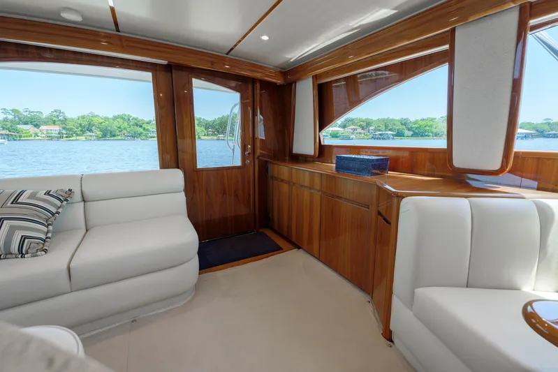 Time Away Yacht Photos Pics Luxurious interior of 2019 Viking 48 Convertible yacht with elegant wood finish and plush seating.