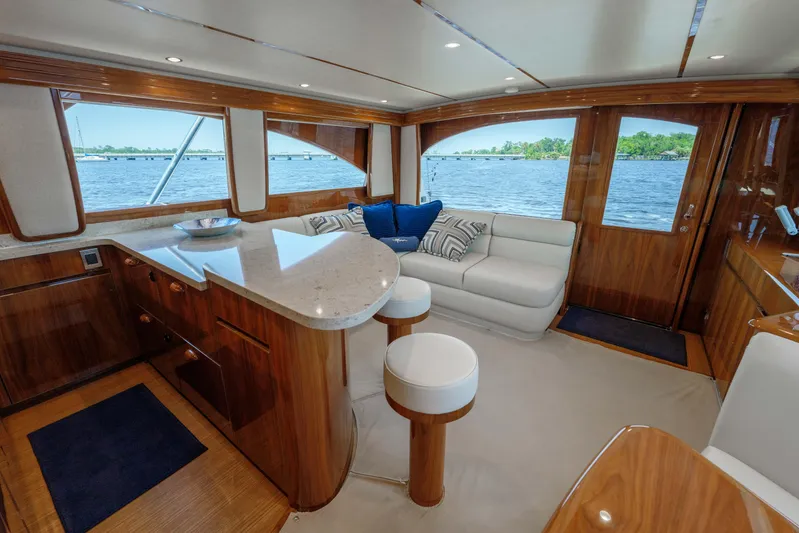 Time Away Yacht Photos Pics Luxurious interior of 2019 Viking 48 Convertible yacht with elegant wood finishes and scenic water views.