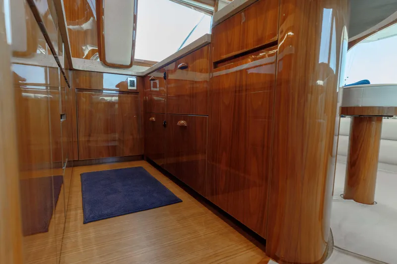 Time Away Yacht Photos Pics Luxurious wooden interior of 2019 Viking 48 Convertible yacht with sleek cabinetry and flooring.