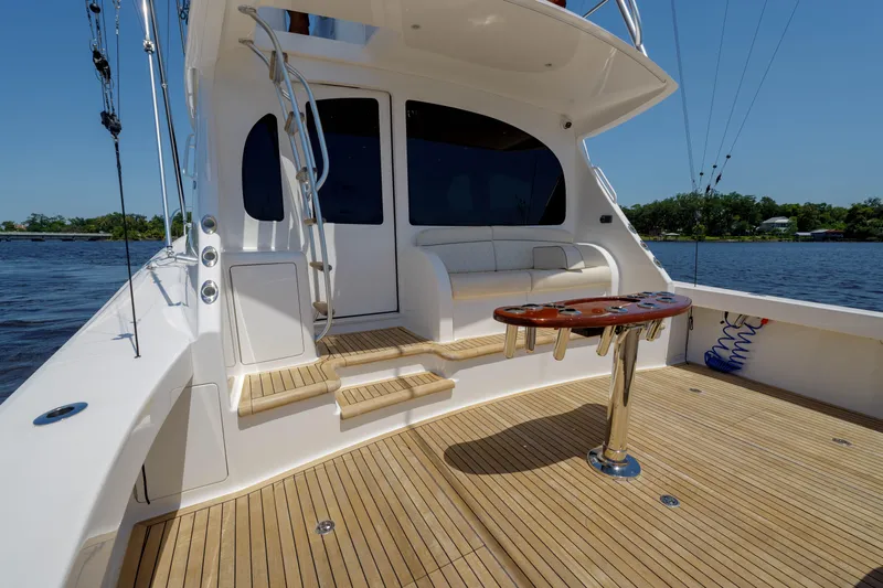 Time Away Yacht Photos Pics 2019 Viking 48 Convertible yacht deck with seating and table, overlooking water.