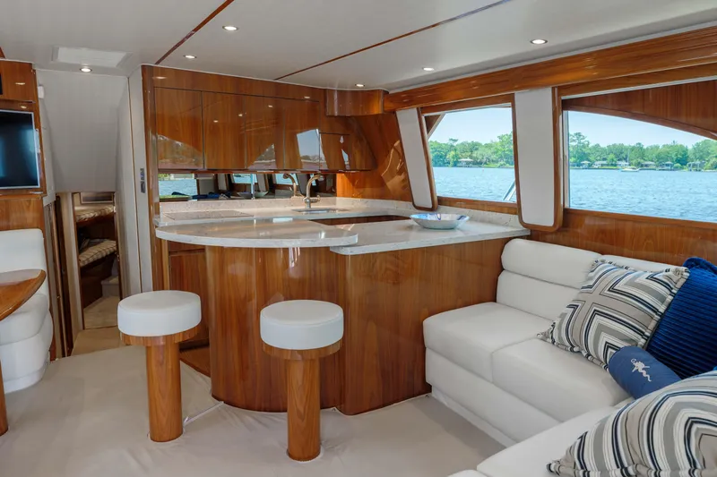 Time Away Yacht Photos Pics Luxurious interior of 2019 Viking 48 Convertible yacht with elegant wood finishes and plush seating.