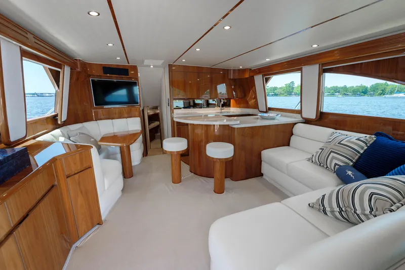 Time Away Yacht Photos Pics Luxurious interior of 2019 Viking 48 Convertible yacht with elegant wood and white furnishings.