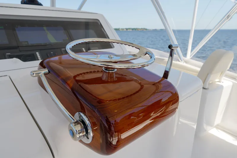 Time Away Yacht Photos Pics Steering wheel of 2019 Viking 48 Convertible yacht with polished wood and chrome finish.