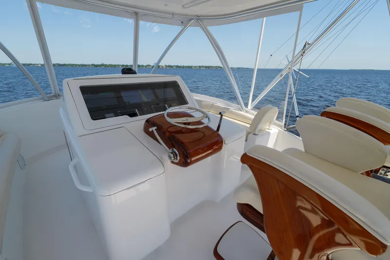 Time Away Yacht Photos Pics 2019 Viking 48 Convertible yacht helm with ocean view, featuring luxurious seating and controls.