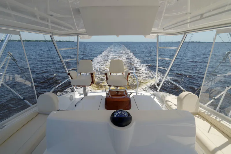 Time Away Yacht Photos Pics 2019 Viking 48 Convertible yacht interior with ocean view and helm chairs.
