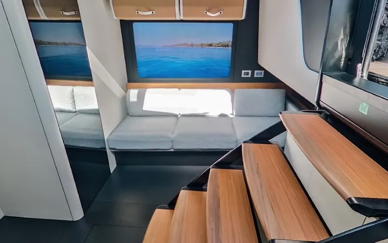  Yacht Photos Pics Luxurious interior of 2023 Wally WALLYPOWER 58X yacht with modern seating and wooden stairs.