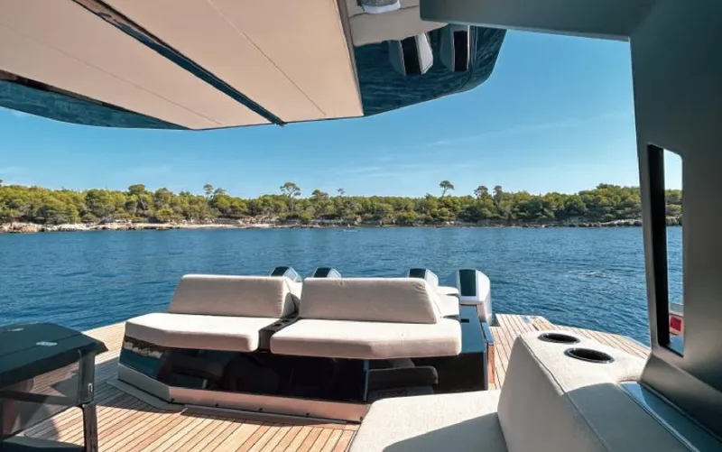  Yacht Photos Pics Luxurious 2023 Wally WALLYPOWER 58X yacht with elegant seating, overlooking serene blue waters.