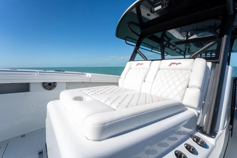  Yacht Photos Pics 2024 Yellowfin 42 Offshore boat with luxurious white seating and ocean backdrop.