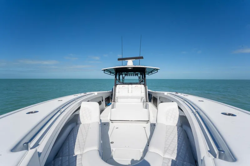 Yacht Photos Pics 2024 Yellowfin 42 Offshore boat on open sea under clear blue sky.