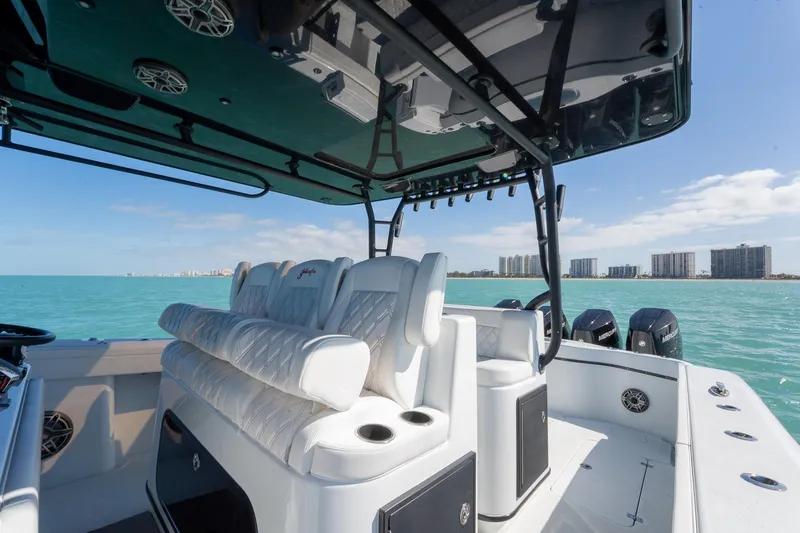  Yacht Photos Pics 2024 Yellowfin 42 Offshore boat interior with luxurious seating, ocean view, and city skyline.