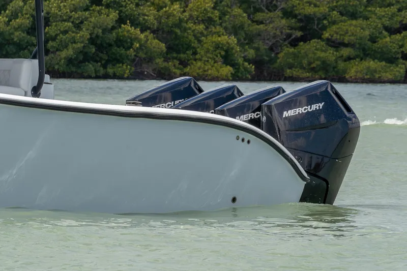  Yacht Photos Pics 2024 Yellowfin 42 Offshore boat with Mercury outboard engines in calm water.